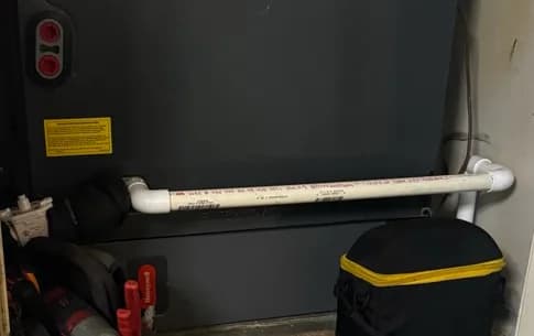 Indoor equipment cabinet and condensate piping from the drain service visit
