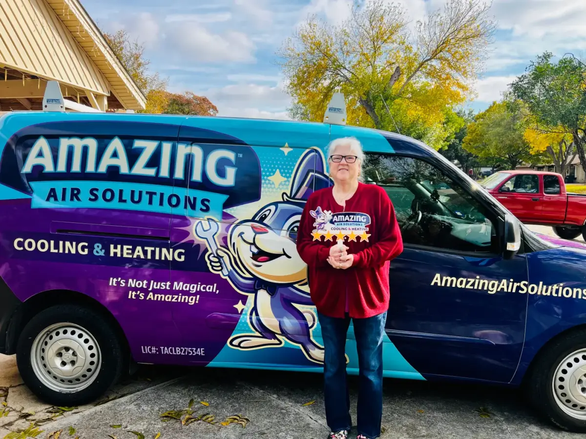 Roy Jaramillo with a customer beside the Amazing Air Solutions service van